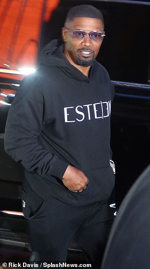 Jamie Foxx and Mexican singer Peso Pluma wore black hoodies to the game.