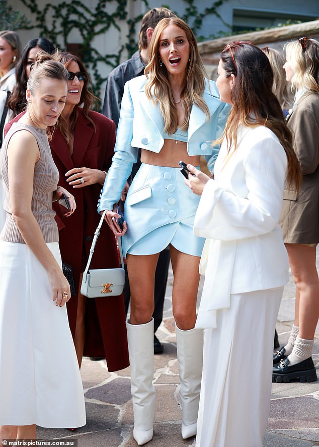 Bec, who is married to Carlton star Chris Judd, gave herself a few extra inches in a pair of white knee-high boots and carried her essentials in a white bag.