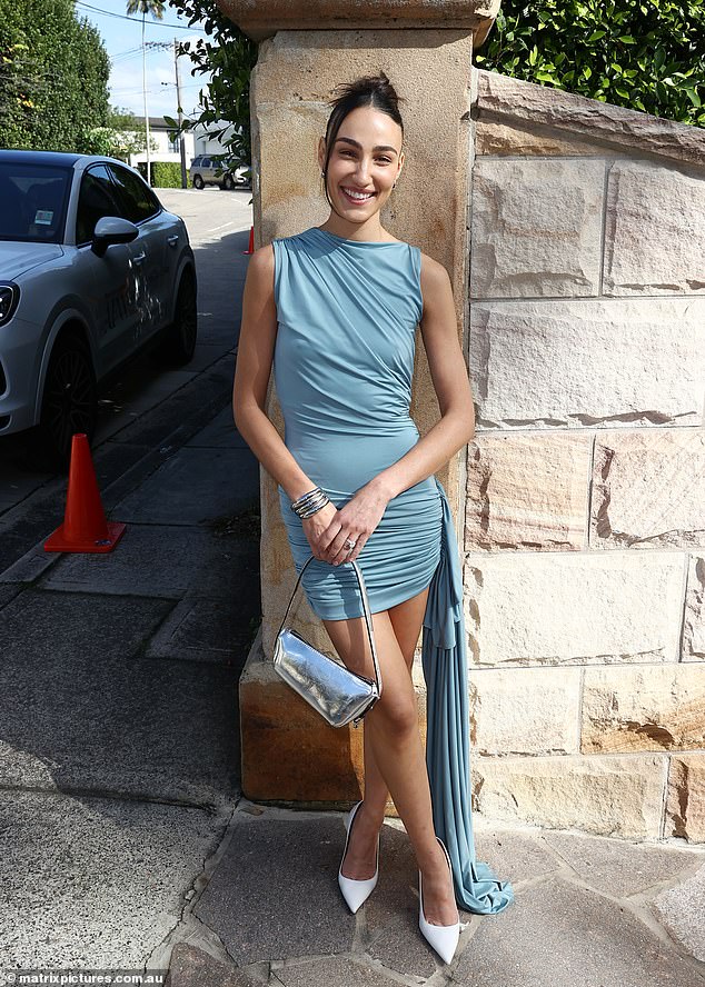 Tayla Broad showed off her incredible figure in a blue mini dress, which she paired with white heels and a silver bag.