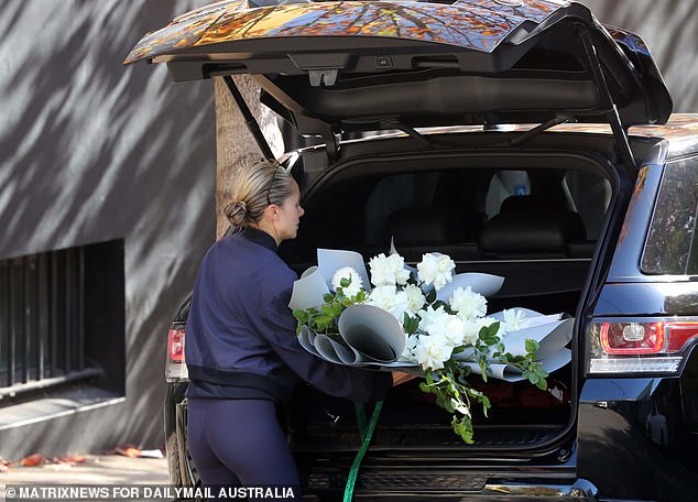 Kelsea Doyle seen packing up her luxury vehicle with a luxurious bouquet