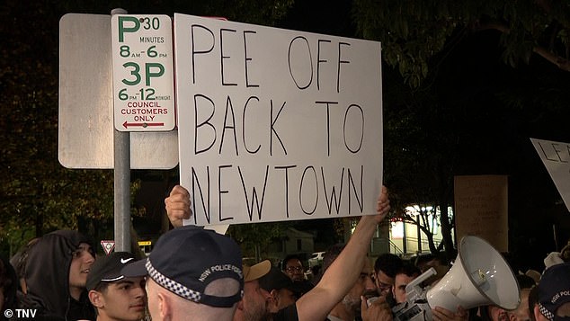 Protesters (pictured) are separated by a heavy police presence due to the emotive issue that has raised tensions in the area and across the city.