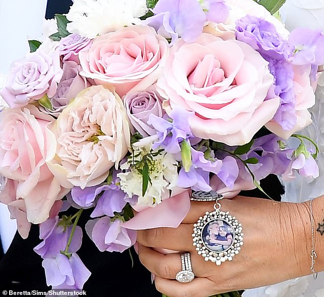 A childhood photo of Anne-Marie and her late father was attached to her bouquet of flowers.