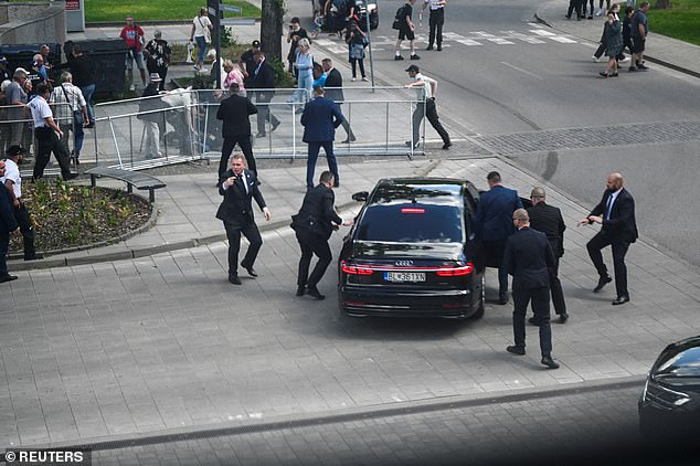 Security officers carry Slovak Prime Minister Robert Fico into a car after a shooting, following a meeting of the Slovak government in Handlova, Slovakia, on May 15, 2024.