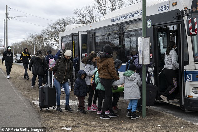 More than 180,000 immigrants have arrived in New York since spring 2022. Pictured: Newly arrived migrants board a bus in front of the Floyd Bennett Field shelter on February 21, 2024.