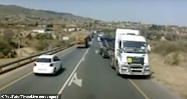 Other vehicles are forced onto the shoulder as the truck moves down the road.