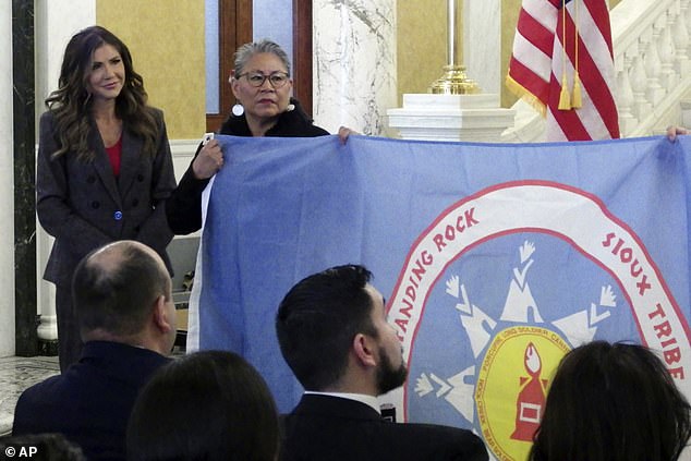 South Dakota Republican Gov. Kristi Noem (left) and Standing Rock Sioux Tribe Chairwoman Janet Alkire during a ceremony where tribal leaders presented flags from the Standing Rock and Rosebud Sioux Tribes in January passed at the state Capitol in Pierre.