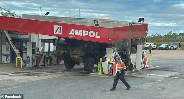 Shattered roof support beams and fuel pumps are severely damaged after the truck hit.