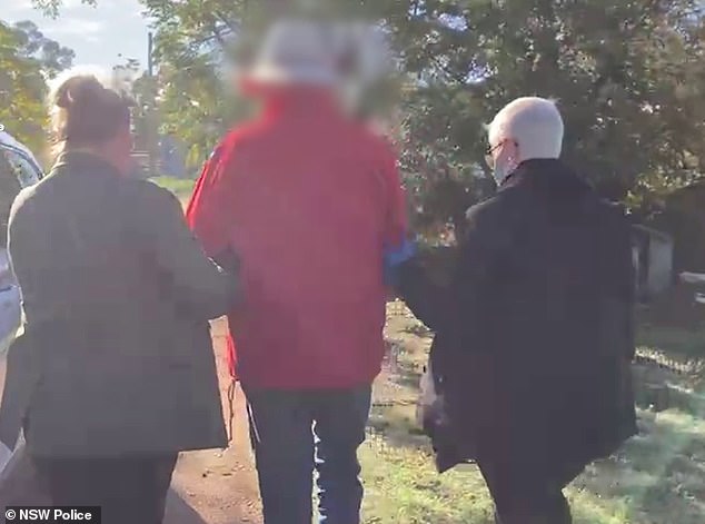 He is pictured being arrested by detectives at his farm on Wednesday.