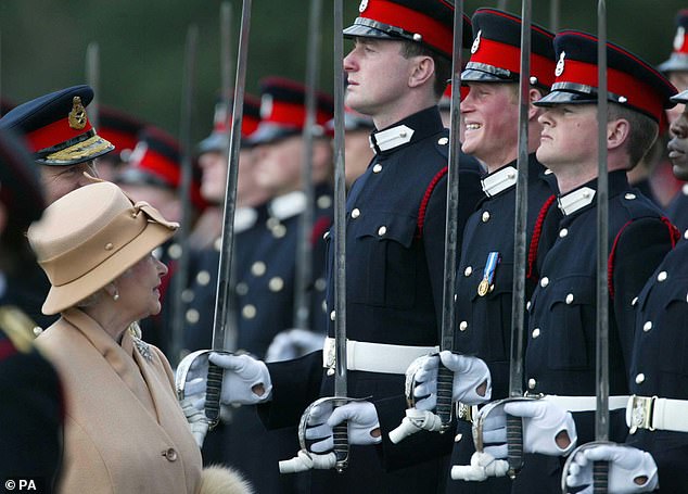 Prince Harry fails to keep a straight face as his grandmother Queen Elizabeth checks on him and his fellow officers during the Sovereign's Parade at the Royal Military Academy Sandhurst.