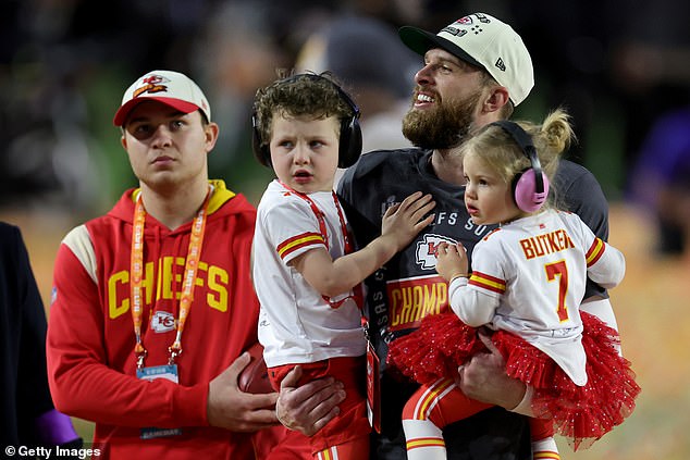 Harrison Butker of the Kansas City Chiefs celebrates with his children after kicking the field goal to beat the Philadelphia Eagles in Super Bowl LVII at State Farm Stadium on February 12, 2023 in Glendale, Arizona.