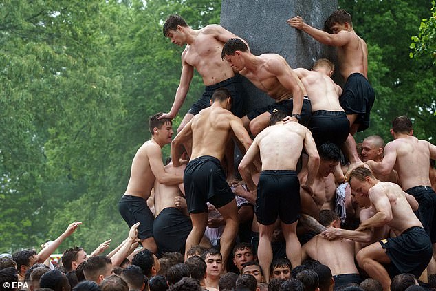 The freshmen formed a human pyramid as they tried to reach the top of the monument.