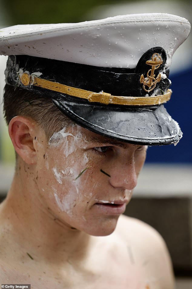 Twenty-year-old Ben Leisegang (pictured) was finally able to remove the Dixie top hat from the top of the obelisk.