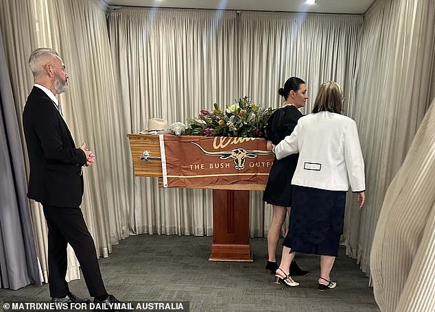 During the service, a ceremonial casket sat on the altar with a decorative flag by RM Williams and a floral arrangement along with a framed photograph of Shane.