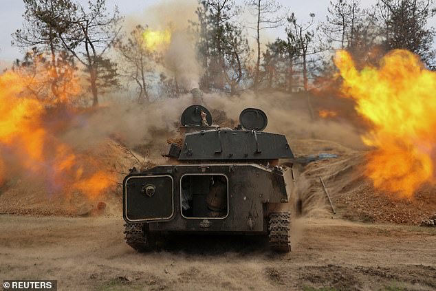 Ukrainian service members from the 37th Marine Brigade fire a 2S1 Gvozdika self-propelled howitzer toward Russian troops, amid Russia's attack on Ukraine.