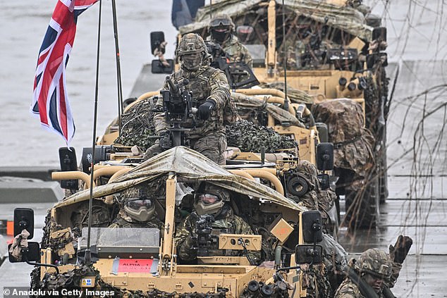 British soldiers stay inside armored vehicles as they cross the Vistula River during the NATO military defense exercises DRAGON-24 on March 5, 2024.