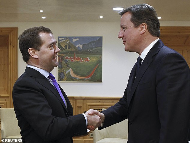 Former Russian president Dmitry Medvedev (right) rattled even more sabers over Ukraine and mocked British Foreign Secretary David Cameron (left).