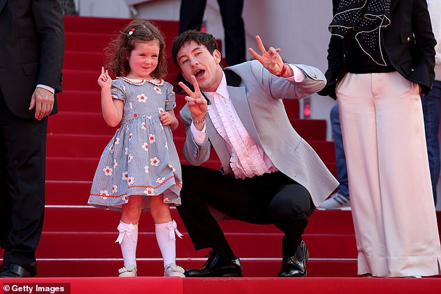 The couple was seen flashing peace signs for waiting photographers before walking up the stairs of the Croisette.