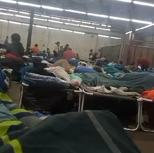 Migrants photographed at a makeshift shelter in Chicago's Pilsen neighborhood, where many are being transferred. There has been an outbreak of measles and tuberculosis linked to the shelter.