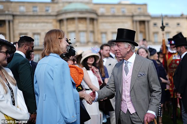 King Charles III greets guests during the Sovereign's Creative Industries garden party at Buckingham Palace on May 15, 2024