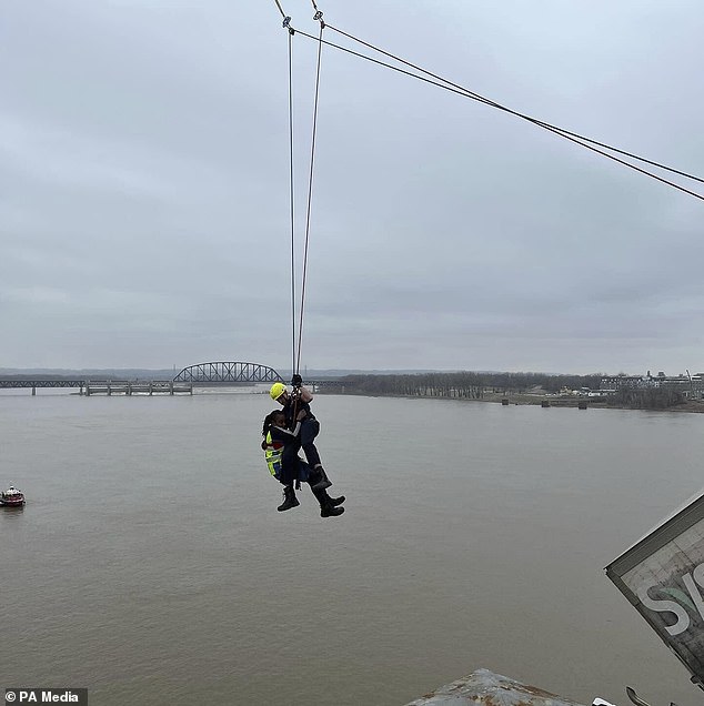 Rescue crews had to make a daring rescue of Thomas after the incident, with Louisville firefighter Bryce Carden dangling from a crane toward her.