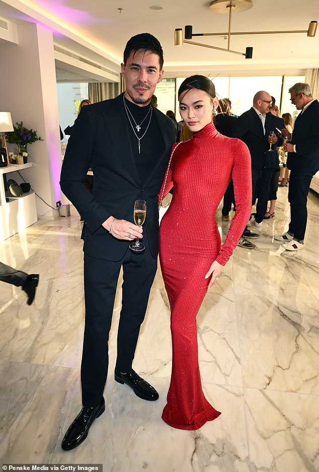 She posed with Lucy Qiu, who wore a figure-hugging red dress.