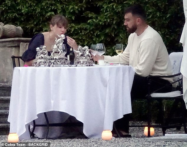 During Taylor and Travis' stay at the villa, they were seen romantically gazing into each other's eyes while dining outside at a small table. The Shake It Off singer cut an elegant figure in a navy blue dress with short puffed sleeves.