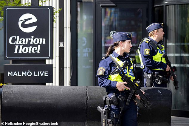 Armed police officers stand in front of the hotel where the Dutch delegation was staying.