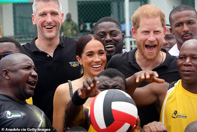 Prince Harry (right) and Meghan, Duchess of Sussex (left) attend an exhibition sitting volleyball match at Nigeria Unconquered, a community charity dedicated to helping wounded, injured or ill service members, as part of the Invictus Games anniversary celebrations. in Abuja, Nigeria, on May 11, 2024