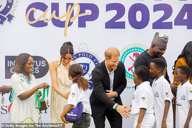 Meghan and Harry greet the children on their visit to the Polo Club on May 12, 2024 in Lagos