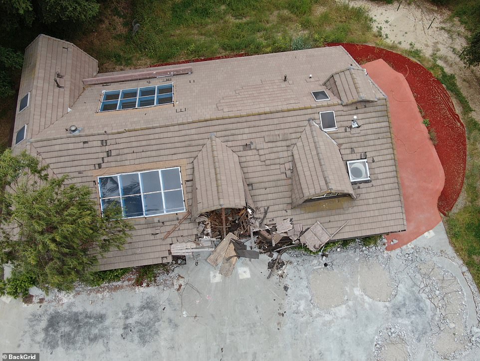 Roof tiles can be seen to be missing and falling off, while green plants and trees apparently grow too close to the front of the main house.