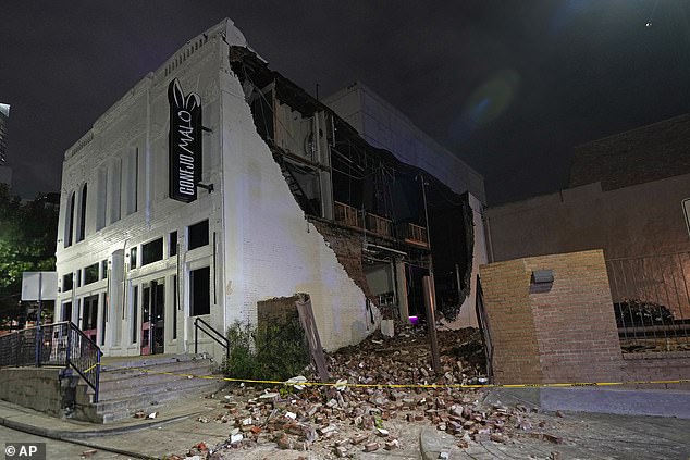 A damaged building is shown after a severe storm passed through downtown, Thursday, May 16, 2024, in Houston. (AP Photo/David J. Phillip)