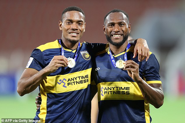 Central Coast Mariners defenders Dan Hall (L) and Brian Kaltak pose with their medals after winning the AFC Cup Final