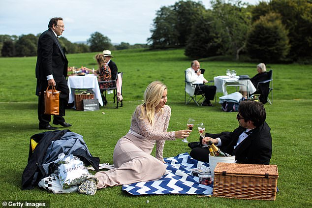 At Glyndebourne, where revelers are seen enjoying a picnic, opera tickets cost more than £200 per person.