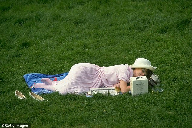 A racist lady takes a nap next to a case of wine during Royal Ascot in Berkshire.