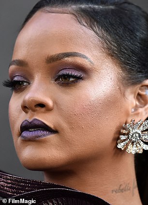 Rihanna, shown in 2018, has blemishes on her cheeks covered with makeup.