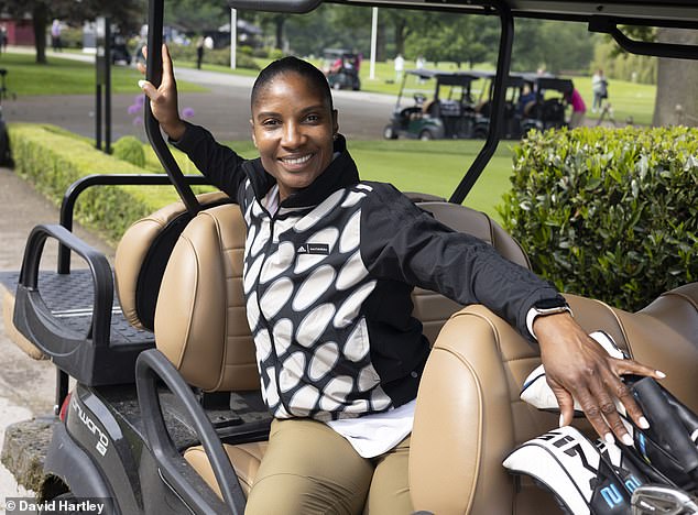 Dame Denise Rosemarie Lewis DBE, the British sports presenter enjoying a trip in a golf cart