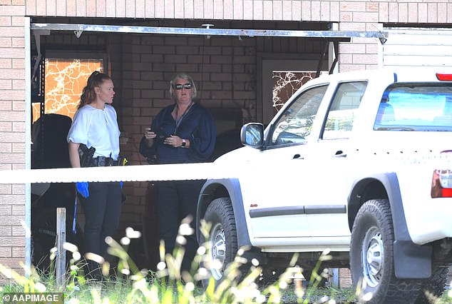 Police arrive at the scene of the robbery in Logan, south of Brisbane, on Friday.