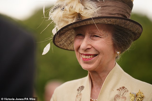 She smiled as she chatted with those at Buckingham Palace today.