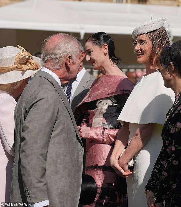 Some of the guests at the event included model Rosie Huntington-Whiteley, who was photographed smiling and chatting with the monarch dressed in an elegant white ensemble.