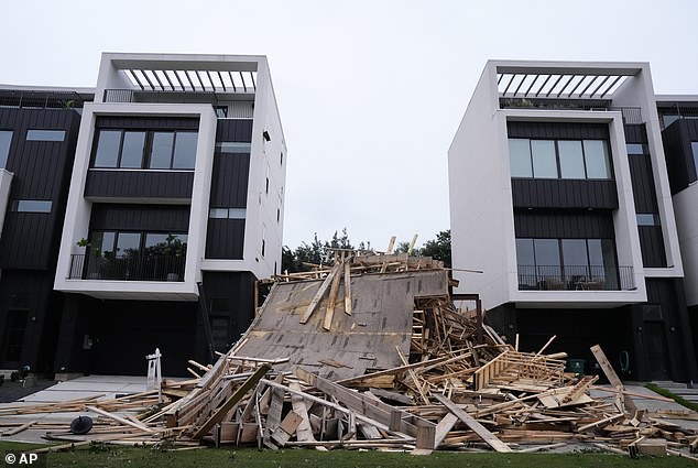 Debris lies in front of a building under construction that collapsed during last night's storm on Memorial Heights Drive.