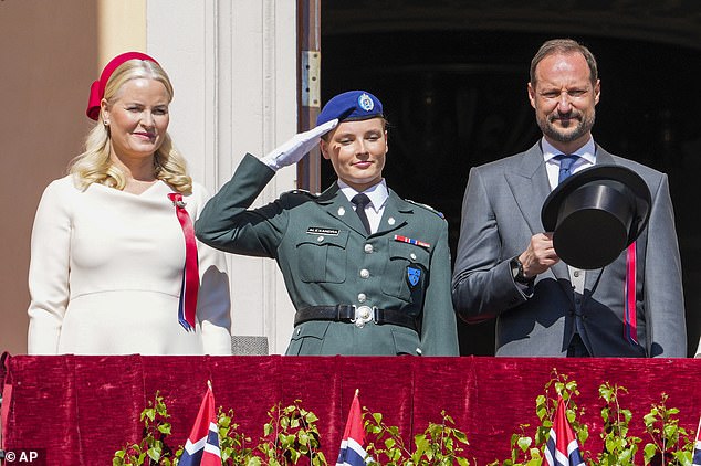 The Norwegian royal daughter of Crown Princess Mette-Marit, 50, (left) and Crown Prince Haakon, 50, (right), looked elegant as she waved from the balcony of her Skaugum estate in Oslo during the Day of the Norwegian Constitution.