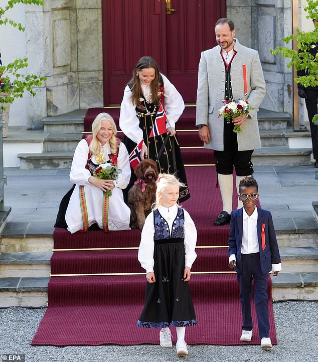 Mette-Marit, Prince Haakon and Ingrid Alexandra waved to the children's train during Constitution Day celebrations.