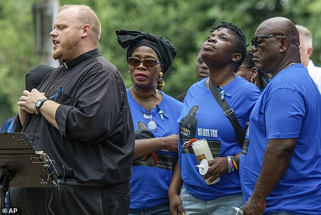 Harris' family prays with the Rev. Jonathan Slavinskas during a vigil in Worcester, Massachusetts, on September 8, 2023.