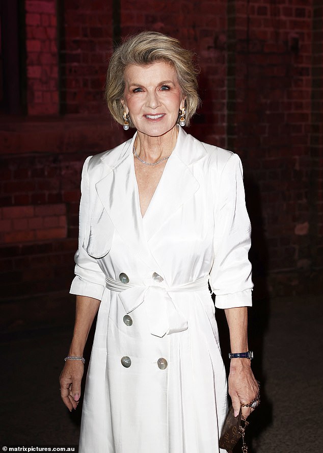 Meanwhile, the fashion icon was all smiles as she posed in a chic white trench coat-inspired dress at the David Jones Indigenous Fashion Projects event on Thursday.