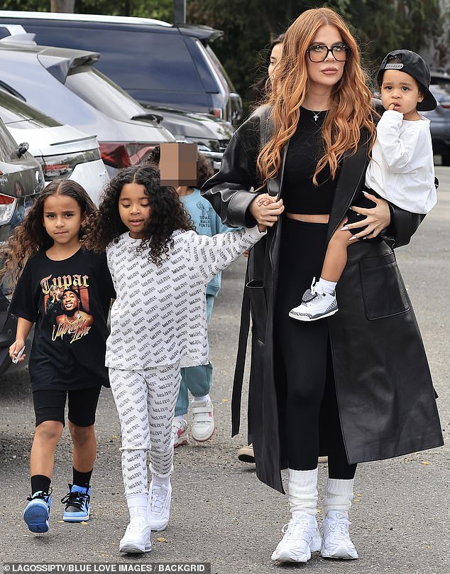 The Kardashian star held her son Tatum, 21 months, while holding hands with her six-year-old daughter True, whom she shares with ex Tristan Thompson.