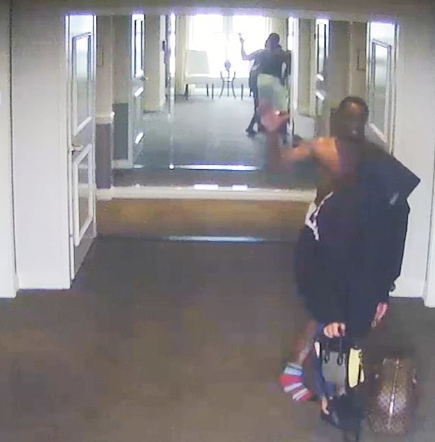 Cassie is seen trying to flee in an elevator. Diddy, after chasing her down the hallway, grabbed her by the back of her sweatshirt and threw her to the floor.