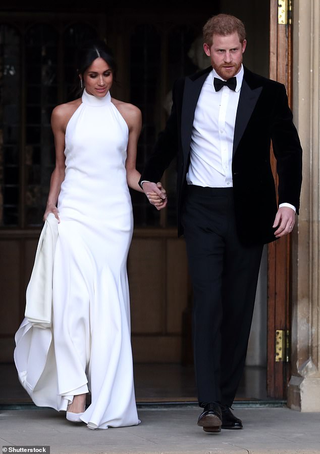 Meghan in one of her royal wedding dresses on the day she married Prince Harry in Windsor in 2018. Made by designer Stella McCartney, it was worn during the less formal part of the day.