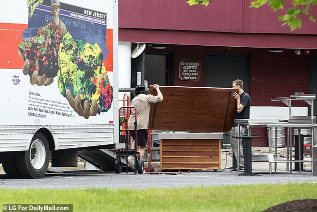 Red Lobster auction winners remove kitchen equipment and furniture from Red Lobster restaurant in Columbia, Maryland