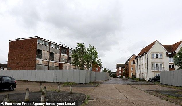 On the left, an abandoned building awaiting demolition, but on the road are newly built houses.