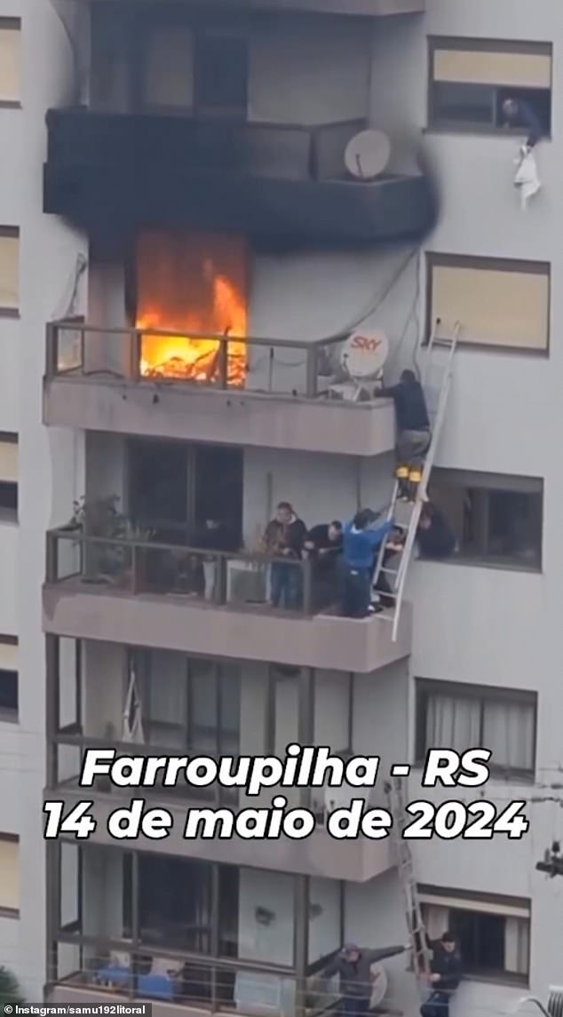 The rescuer reaches out to grab the terrified boy while his team clings to the ladder. The child's mother was taken to the hospital with burns covering 60 percent of her body.